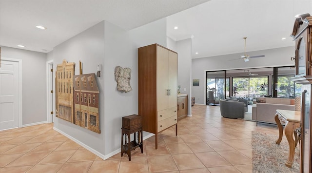 corridor featuring light tile patterned flooring, recessed lighting, and baseboards