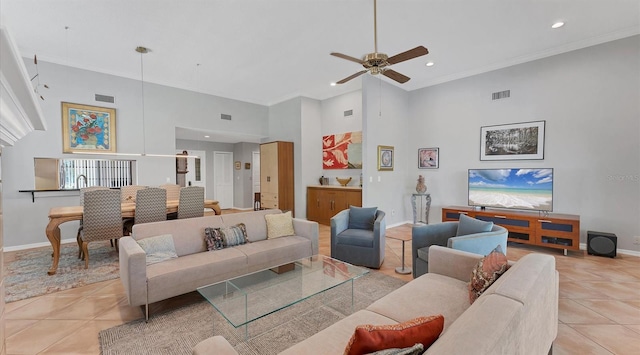 living area featuring visible vents, crown molding, ceiling fan, a towering ceiling, and light tile patterned flooring