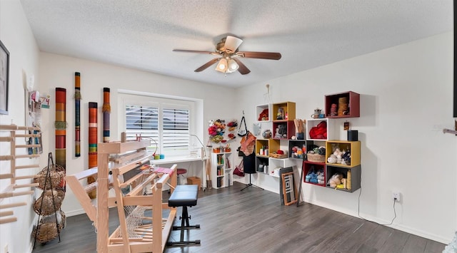 interior space with a textured ceiling, wood finished floors, and ceiling fan