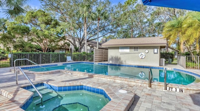 community pool with a community hot tub and fence