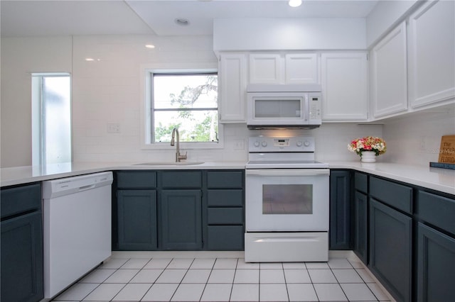 800 Everest Rd, Venice, FL 34293 - kitchen featuring a sink, white appliances, tasteful backsplash, white cabinetry, and light countertops