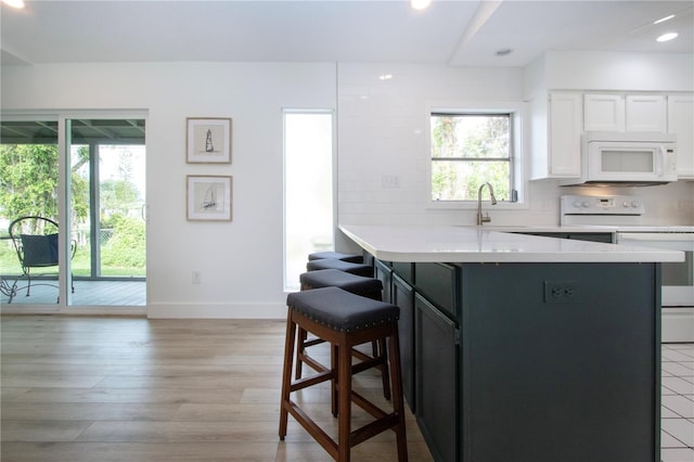800 Everest Rd, Venice, FL 34293 - kitchen with a breakfast bar area, white appliances, plenty of natural light, and a sink