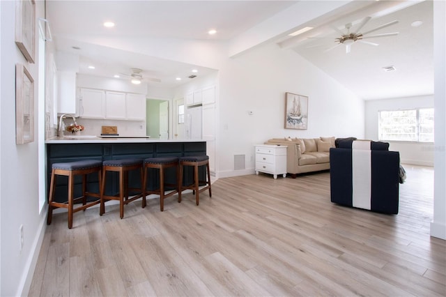 800 Everest Rd, Venice, FL 34293 - living area featuring light wood-type flooring, visible vents, lofted ceiling with beams, and a ceiling fan