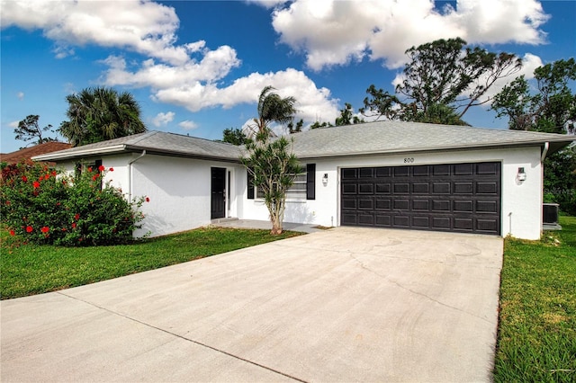 800 Everest Rd, Venice, FL 34293 - ranch-style home with a front lawn, stucco siding, central AC, concrete driveway, and an attached garage