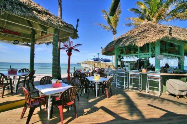 800 Everest Rd, Venice, FL 34293 - wooden deck featuring outdoor dry bar, outdoor dining area, and a water view