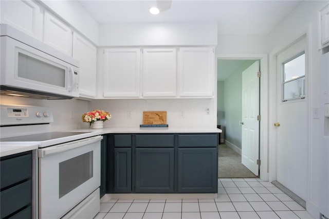 800 Everest Rd, Venice, FL 34293 - kitchen featuring white cabinetry, light colored carpet, light countertops, white appliances, and backsplash