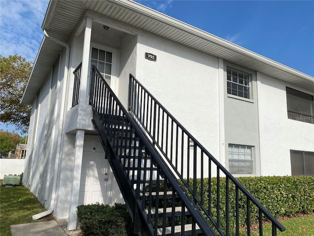 property entrance with stucco siding