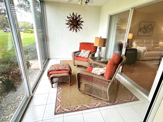 sunroom / solarium with a ceiling fan