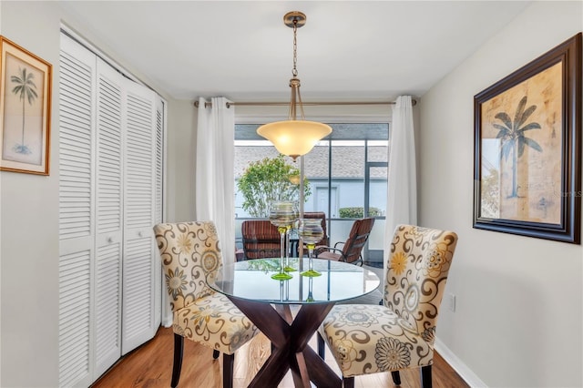 dining room with wood finished floors and baseboards