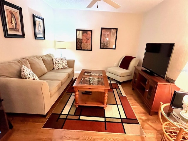 living room with ceiling fan and wood finished floors