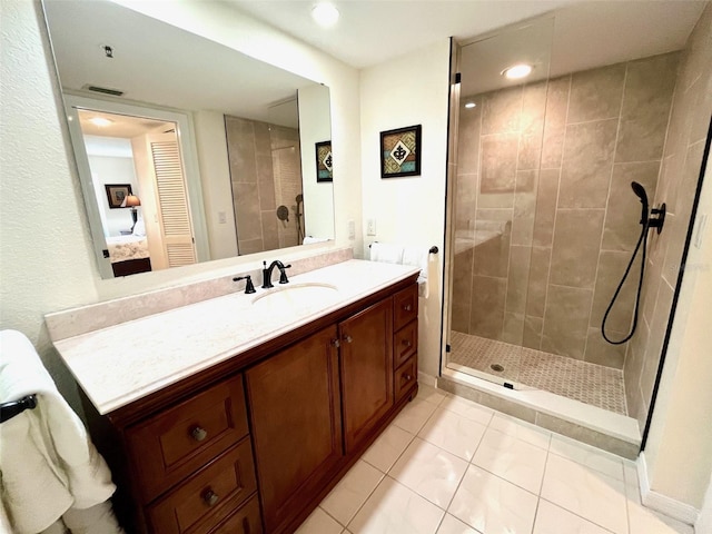 full bathroom featuring vanity, visible vents, tiled shower, tile patterned flooring, and ensuite bathroom