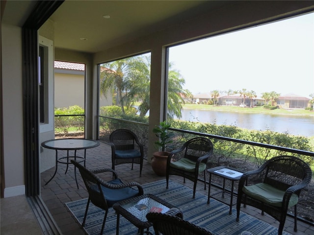 sunroom / solarium with a water view