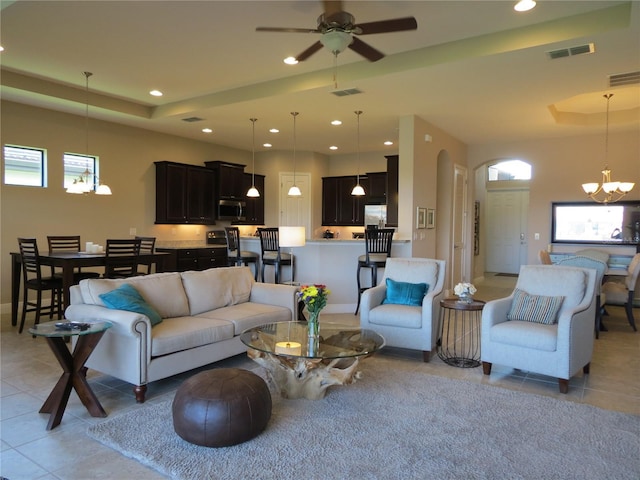 living area featuring recessed lighting, a tray ceiling, and visible vents