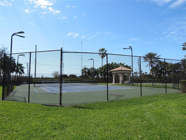 view of sport court with a gazebo, a yard, and fence