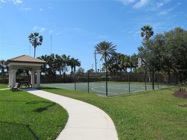 view of basketball court with a gazebo, community basketball court, a lawn, and fence