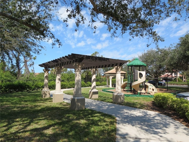 surrounding community with a pergola, playground community, a yard, and fence