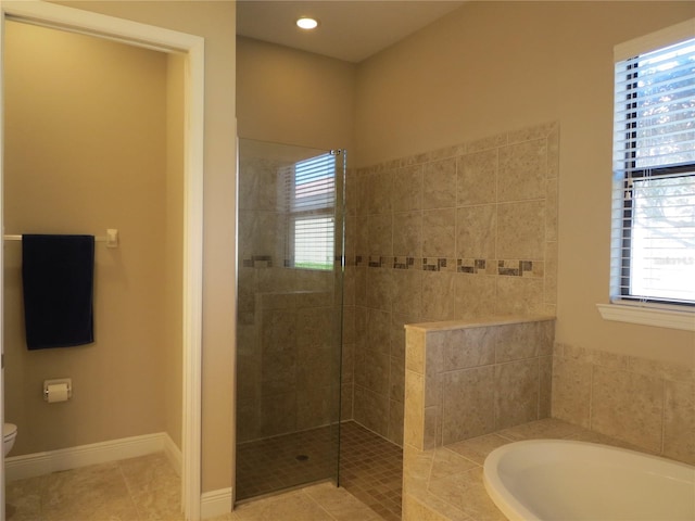 bathroom with tile patterned floors, a garden tub, toilet, baseboards, and walk in shower