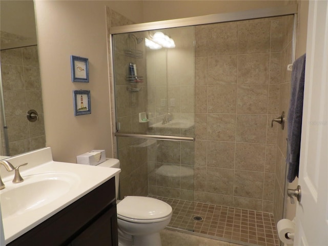 bathroom with vanity, toilet, and a shower stall