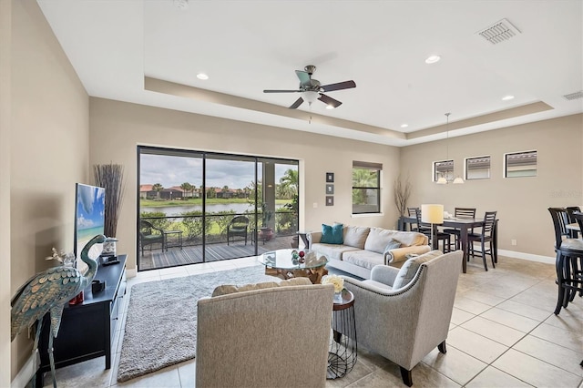 1290 Cielo Ct, North Venice, FL 34275 - living room featuring a raised ceiling, ceiling fan, light tile patterned floors, recessed lighting, and baseboards