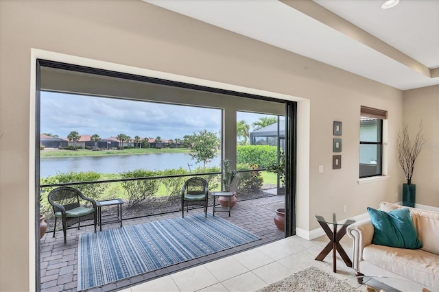 1290 Cielo Ct, North Venice, FL 34275 - doorway with a water view, light tile patterned floors, and baseboards