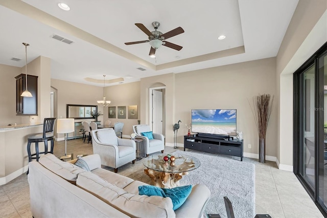 1290 Cielo Ct, North Venice, FL 34275 - living area with a raised ceiling, light tile patterned floors, a ceiling fan, a chandelier, and baseboards