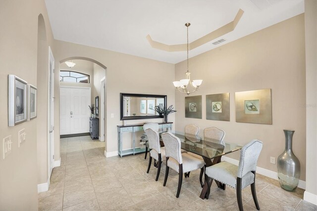 1290 Cielo Ct, North Venice, FL 34275 - dining area with arched walkways, a chandelier, baseboards, and light tile patterned floors