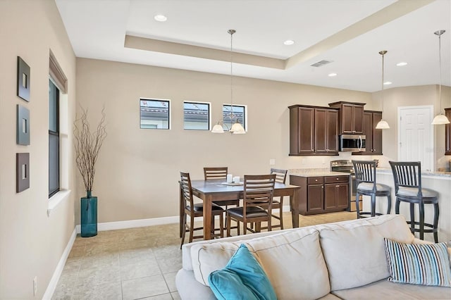 1290 Cielo Ct, North Venice, FL 34275 - living area featuring baseboards, recessed lighting, a tray ceiling, and light tile patterned flooring