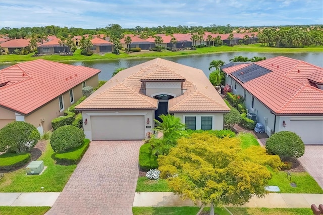 1290 Cielo Ct, North Venice, FL 34275 - view of front of house with a residential view, stucco siding, a garage, a water view, and a tiled roof