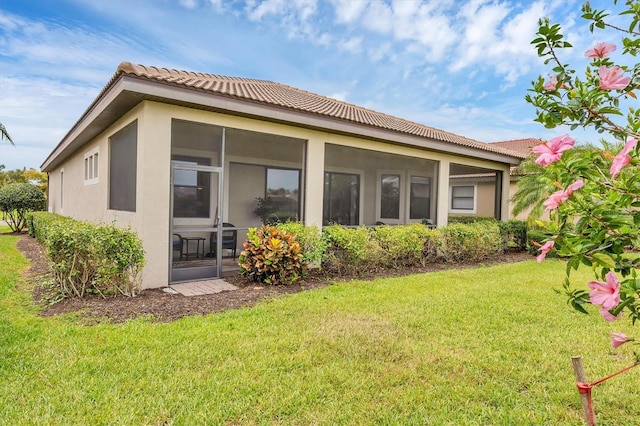 1290 Cielo Ct, North Venice, FL 34275 - back of property featuring a tiled roof, stucco siding, a yard, and a sunroom