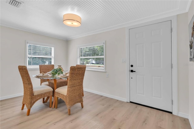 dining area with baseboards, visible vents, and light wood finished floors