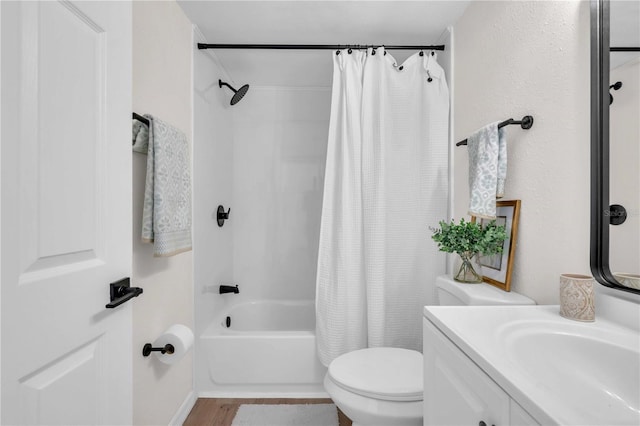 full bath featuring wood finished floors, toilet, vanity, and shower / bathtub combination with curtain