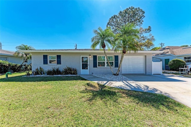 single story home with stucco siding, a front lawn, an attached garage, and driveway