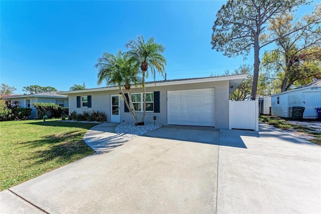 ranch-style house with concrete driveway, a garage, and stucco siding