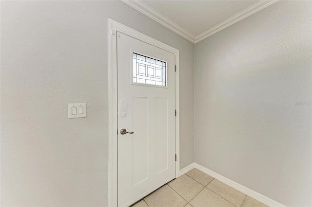 foyer entrance with crown molding, light tile patterned flooring, and baseboards