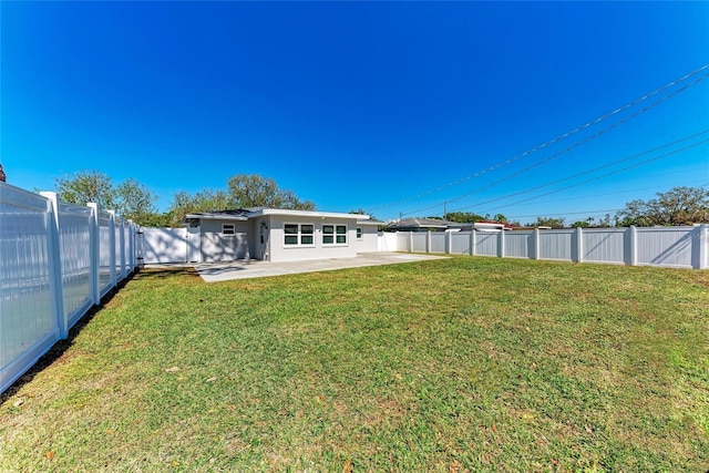 view of yard with a fenced backyard and a patio area