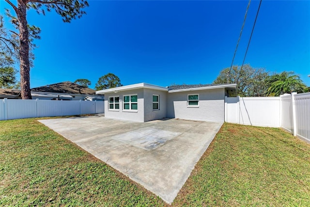 back of property featuring a patio area, a lawn, a fenced backyard, and stucco siding