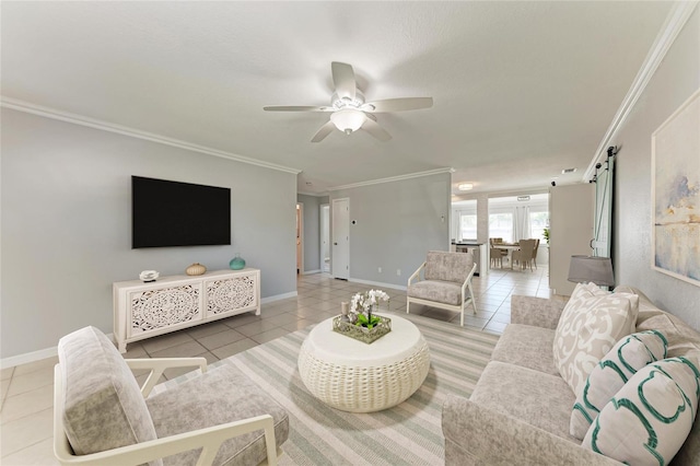 tiled living area featuring a barn door, baseboards, and crown molding