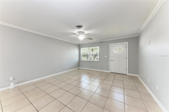 empty room with visible vents, crown molding, baseboards, ceiling fan, and light tile patterned floors