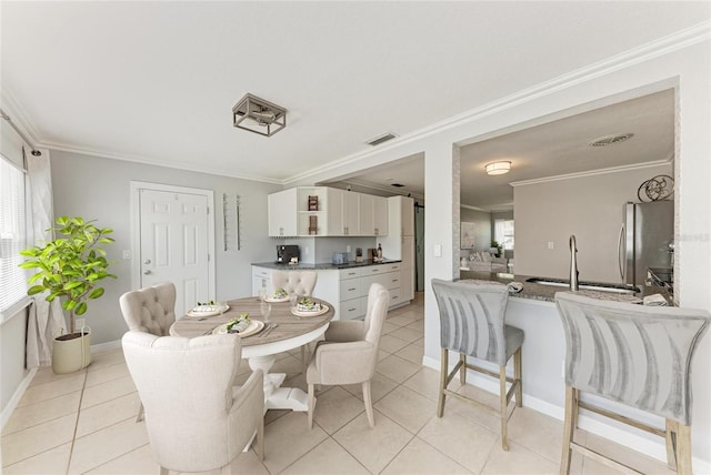 dining room with plenty of natural light and crown molding