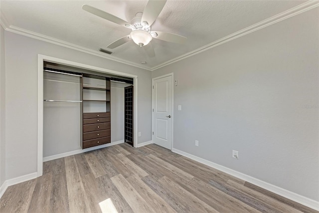 unfurnished bedroom with visible vents, a closet, crown molding, and light wood finished floors