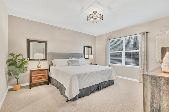 bedroom featuring baseboards and light colored carpet