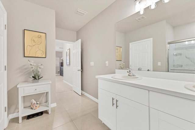 full bath featuring double vanity, a stall shower, a sink, and visible vents