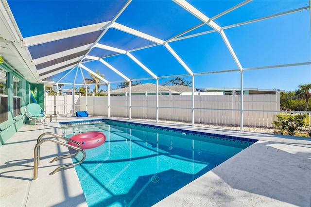 view of swimming pool with a patio area, a fenced in pool, glass enclosure, and fence