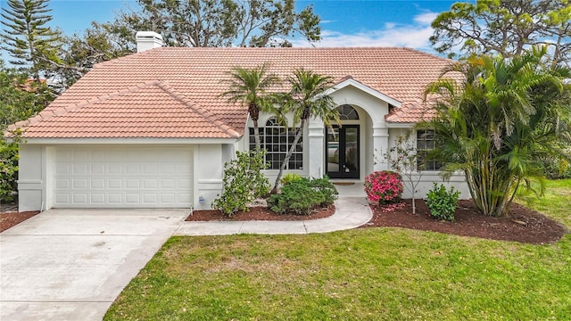 mediterranean / spanish-style home featuring a front lawn, a tiled roof, an attached garage, and a chimney