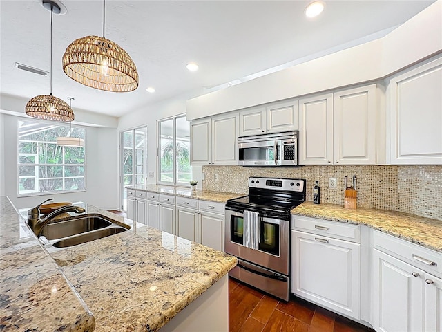 kitchen with decorative backsplash, recessed lighting, dark wood-style floors, stainless steel appliances, and a sink