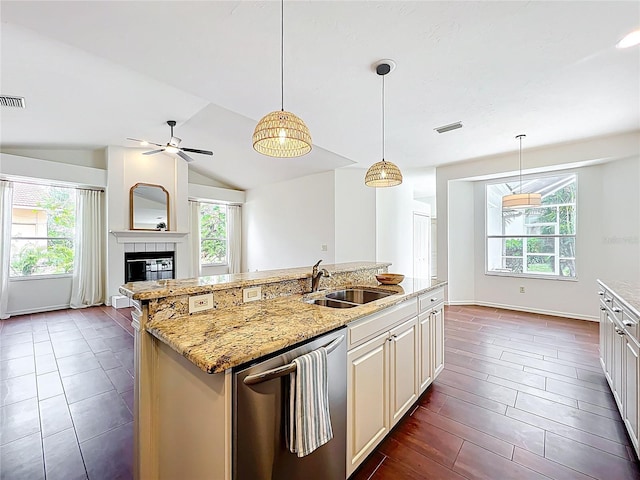 kitchen featuring dishwasher, vaulted ceiling, a healthy amount of sunlight, and a sink