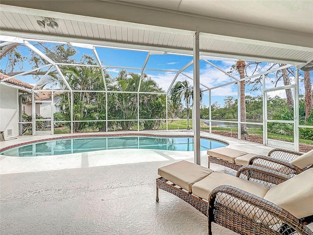 pool with an outdoor living space, a patio, and a lanai