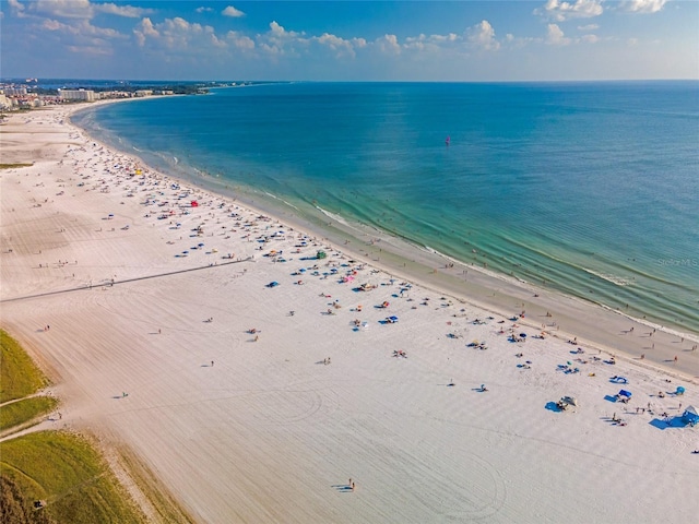 drone / aerial view with a water view and a beach view