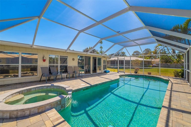 view of pool with a patio, a lanai, and a pool with connected hot tub