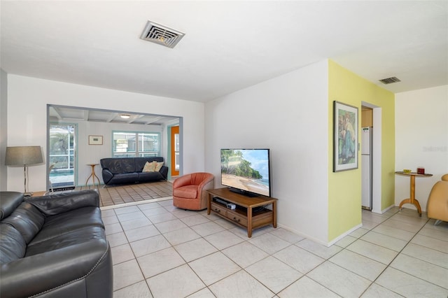 living area with light tile patterned flooring, baseboards, and visible vents